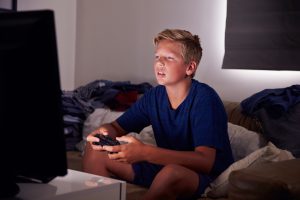 Teenage Boy Addicted To Video Gaming At Home